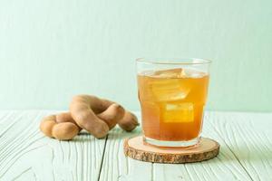 Delicious sweet drink tamarind juice and ice cube photo