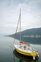 SARNICO, ITALY - OCTOBER 12, 2014. Yellow yacht moored on Lake Iseo at Sarnico photo