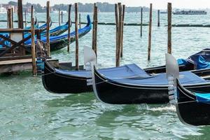 VENICE, ITALY - OCTOBER 12, 2014. Gondolas moored at the entrance to the Grand Canal photo