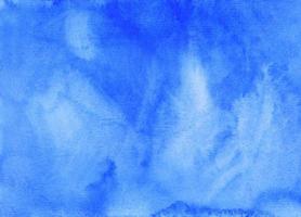 Watercolor watery light blue background painting. Hand painted watercolour backdrop texture. Sky blue stains on paper. photo