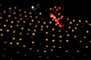 Golden Red Dfocus Abstract bokeh light effects on the night black background texture photo