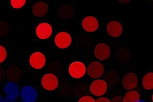 Red Defocus Abstract bokeh light effects on the night black background texture photo