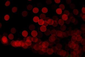 Red Defocus Abstract bokeh light effects on the night black background texture photo