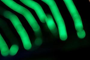 Green Defocus Abstract bokeh light effects on the night black background texture photo