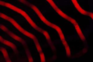 Red Defocus Abstract bokeh light effects on the night black background texture photo