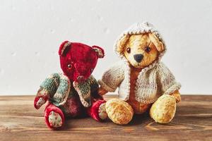 TwoTeddy bears on wooden background photo