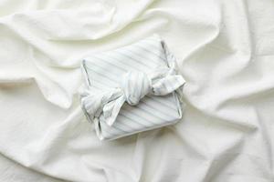 Eco-friendly gift wrap in traditional japanese furoshiki style, eco-friendly gift wrap and Zero Wast concept photo