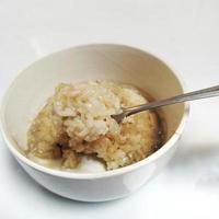 white glutinous rice served in a bowl isolated on a white background photo