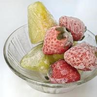 frozen strawberry and frozen melon isolated on white background photo