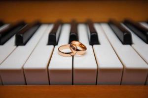 Gold wedding rings on the piano keys photo