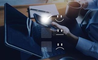 satisfacción y concepto de servicio al cliente, los empresarios están tocando la pantalla virtual en el icono de la carita feliz para dar satisfacción en el servicio. calificación muy impresionado. foto
