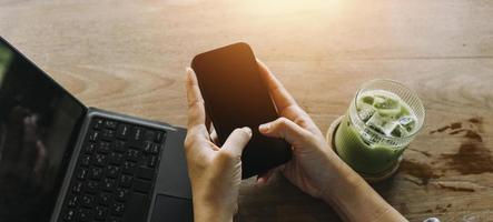 Businessman hands working with finances about cost and calculator and laptop with tablet, smartphone at office in morning light photo