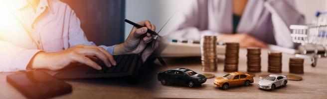 Businessman hands working with finances about cost and calculator and laptop with tablet, smartphone at office in morning light photo