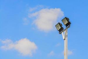 Spotlight in the blue sky with clouds. photo
