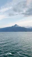 Static shot of Alaskan mountain with moon visible in the daylight sky video