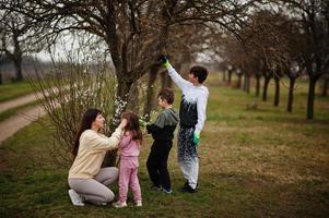 Mother with kids working in spring garden. photo