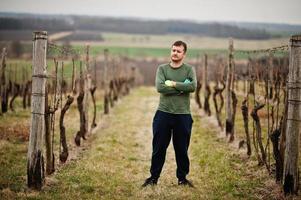 Portrait of man working on vineyard. photo