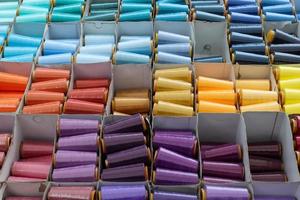 Detailed close up view on samples of cloth and fabrics in different colors found at a fabrics market photo