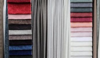 Detailed close up view on samples of cloth and fabrics in different colors found at a fabrics market photo
