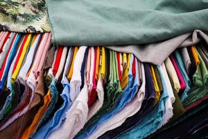 Detailed close up view on samples of cloth and fabrics in different colors found at a fabrics market photo