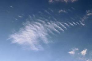 Stunning cirrus cloud formation panorama in a deep blue sky photo