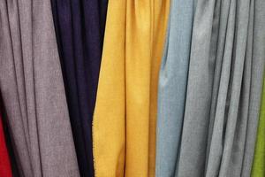 Detailed close up view on samples of cloth and fabrics in different colors found at a fabrics market photo