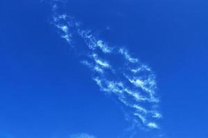 Stunning cirrus cloud formation panorama in a deep blue sky photo