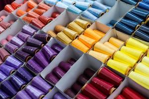 Detailed close up view on samples of cloth and fabrics in different colors found at a fabrics market photo