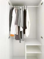 Wardrobe with basic clothes in room scandi interior. photo