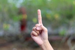 Showing numbers using sign language with female hands in isolated background photo