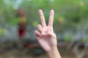 Showing numbers using sign language with female hands in isolated background photo