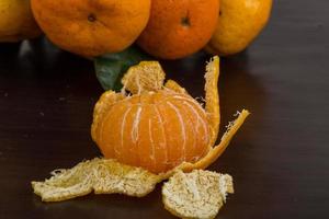 Tangerine on wooden background photo