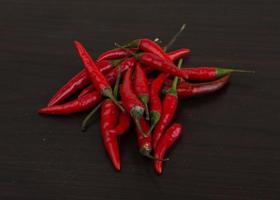 Chili peppers on wooden background photo