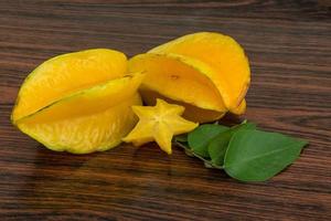 Carambola on wooden background photo