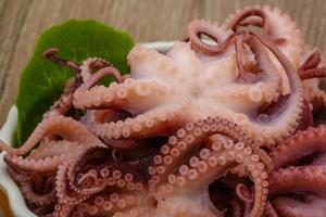 Marinated octopus in a bowl close up view