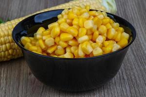 Sweet corn in a bowl on wooden background photo