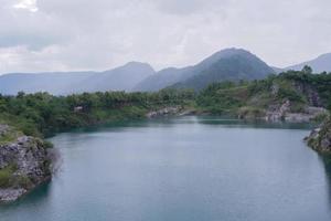 The limestone mountains after the concession explosion during the rainy season form a large and beautiful pond. photo