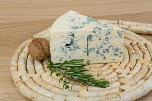 Blue cheese on wooden board and wooden background photo