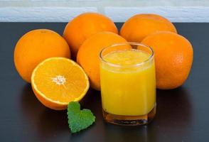 Orange juice on wooden background photo