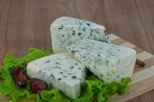 Blue cheese on wooden board and wooden background photo