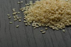 Sesame seeds on wooden background photo