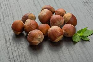 Hazelnut heap on wooden background photo