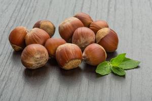 Hazelnut heap on wooden background photo