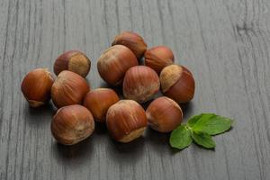 Hazelnut heap on wooden background photo