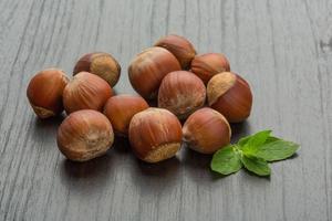 Hazelnut heap on wooden background photo