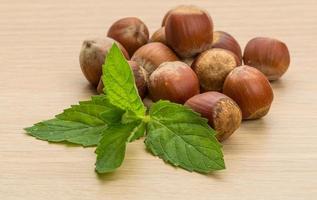 Hazelnut heap on wooden background photo