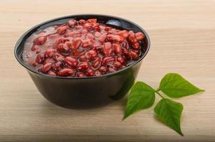 Red beans in a bowl on wooden background photo