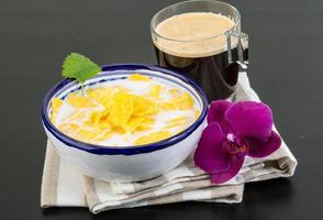 Cornflakes in a bowl on wooden background photo