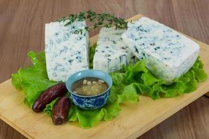 Blue cheese on wooden board and wooden background photo