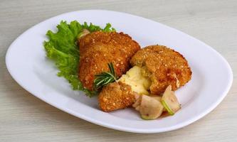 Fried cheese on the plate and wooden background photo